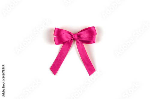 Shiny pink silk ribbon on white background.