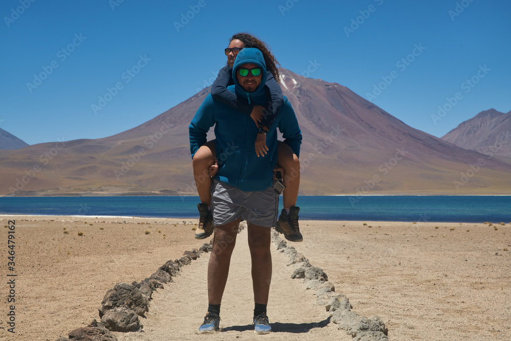 Travelers enjoying at Miscanti Lagoon. Flamingos National Reserve Conaf. San Pedro de Atacama, Antofagasta - Chile. Desert. Andes Range & Route 23. Travelers enjoying at Miscanti Lagoon. Flamingos National Reserve Conaf. San Pedro de Atacama, Antofagasta - Chile. Desert. Andes Range & Route 23.