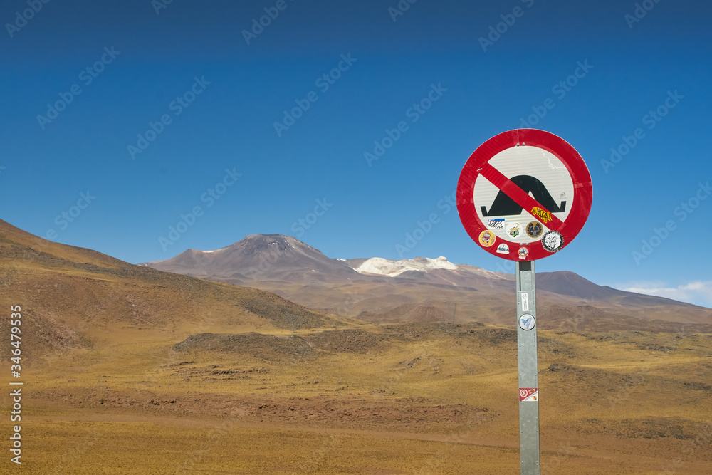 Surroundings and way to Red Rock, camping prohibited sign. Flamingos National Reserve Conaf. San Pedro de Atacama, Antofagasta - Chile. Desert. Andes Range & Route 23.