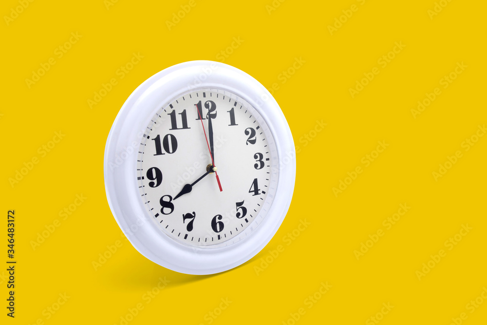 Modern wall clock white isolated on yellow background, time and period, office timepiece and mockup with hour and minute, hour hand, object classic. Modern wall clock white isolated on yellow background, time and period, office timepiece and mockup with hour and minute, hour hand, object classic.
