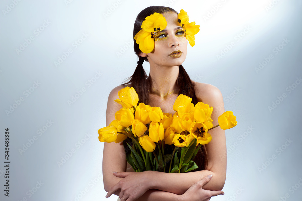 Beauty portrait of a brunette with extended eyelashes in the image of a tulip. Beauty portrait of a brunette with extended eyelashes in the image of a tulip.