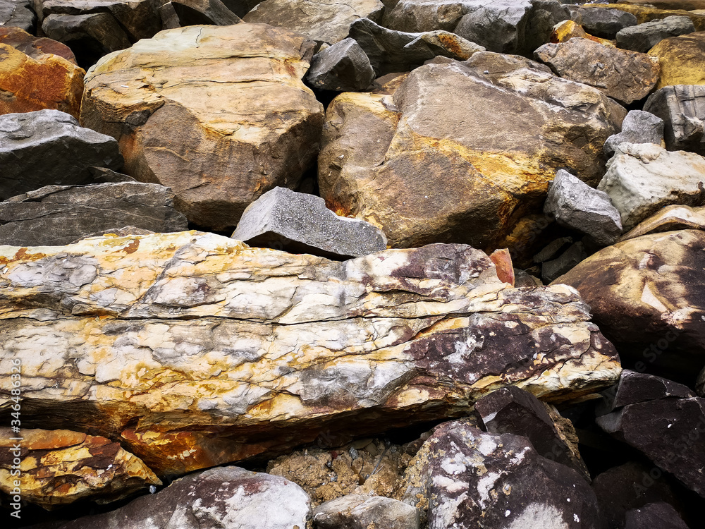 Rugged surface of rocks weathered by elements found in forest and hiking trails