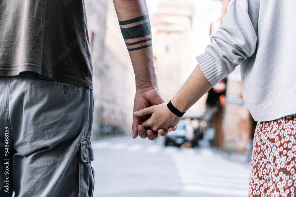 Couple holding hands in the street