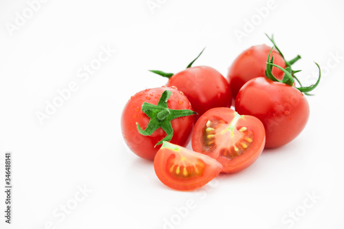 Closeup of tomato white on white background. Healthy vegan food. Tomato top view. White background. Studio shot. Cherry isolated. Healthy vegetarian food. Cherry set.