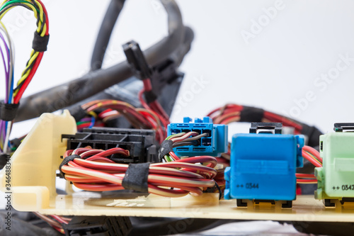 Close-up of a blue connector and a red power channel against a background of tangled wires and digital channels. Connecting Internet network of an IT developer at a remote site.