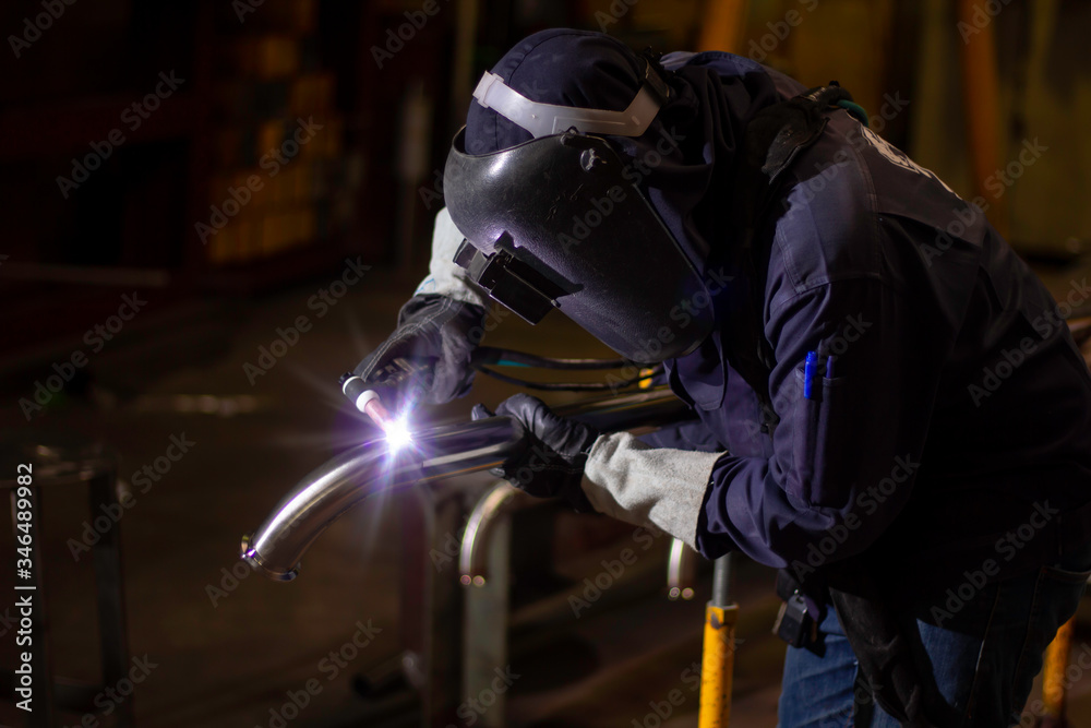 Metal workers use manual labor. Skilled welder. Factory workers making OT. Welder is welding the steel in the factory. welder Industrial automotive part in factory. Metal workers use manual labor. Skilled welder. Factory workers making OT. Welder is welding the steel in the factory. welder Industrial automotive part in factory.