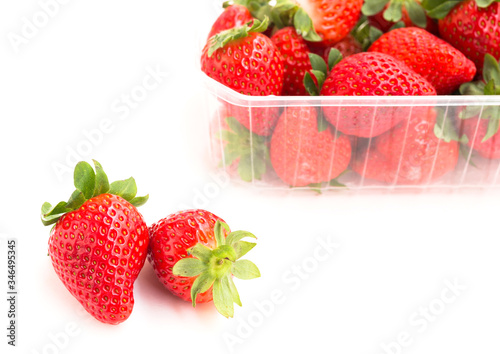 fresh appetizing strawberries in a plastic tray onwhite background