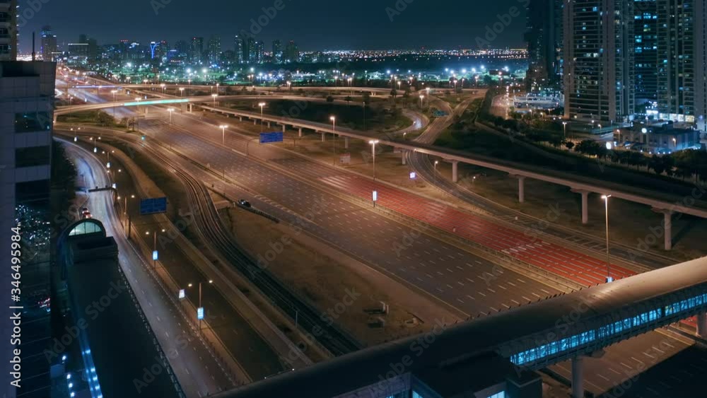 Aerial night view of empty highway and interchange in Dubai after epidemic lockdown. Cityscapes with disappearing traffic on streets. Roads and lanes crossroads without cars, Dubai marina and JLT Aerial night view of empty highway and interchange in Dubai after epidemic lockdown. Cityscapes with disappearing traffic on streets. Roads and lanes crossroads without cars, Dubai marina and JLT