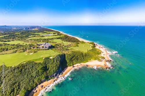 Fototapeta Naklejka Na Ścianę i Meble -  Shanqin Bay, Wanning County, Hainan Island, a Seaside Golf Course Built on a Rolling Land that Overlooks the South China Sea. Aerial View.