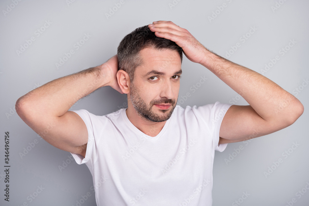 Close-up portrait of his he nice attractive well-groomed content brunet guy touching caressing hairstyle isolated over light grey pastel color background Close-up portrait of his he nice attractive well-groomed content brunet guy touching caressing hairstyle isolated over light grey pastel color background
