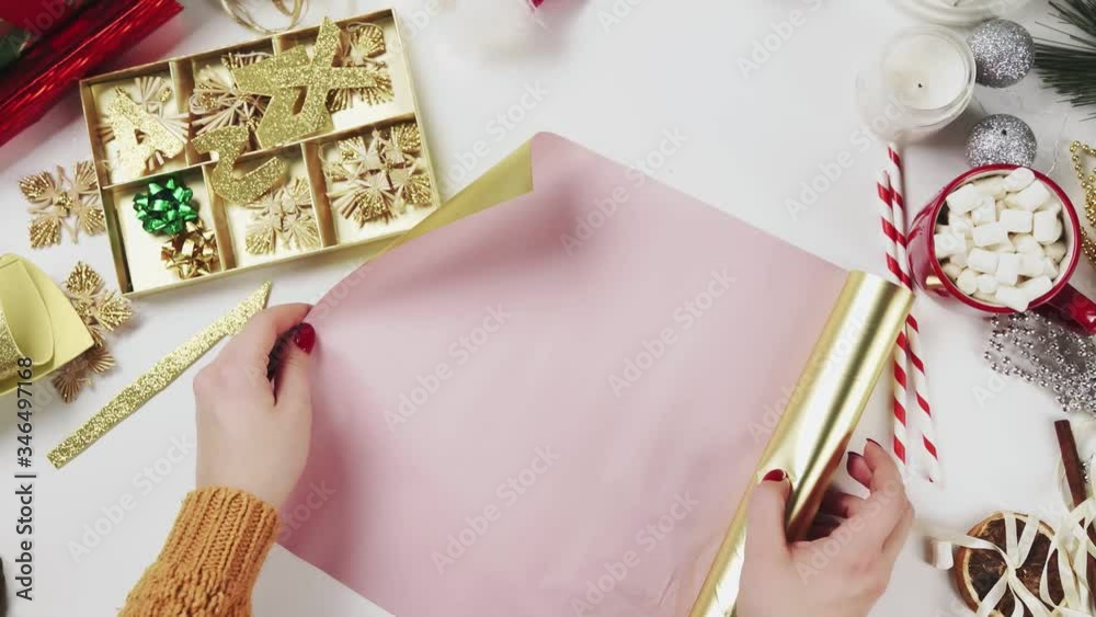 Woman preparing paper to wrapping Christmas Presents Woman preparing paper to wrapping Christmas Presents