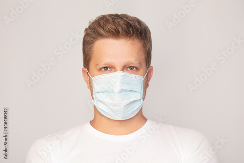 Portrait of a man adult young in a medical mask on an isolated background