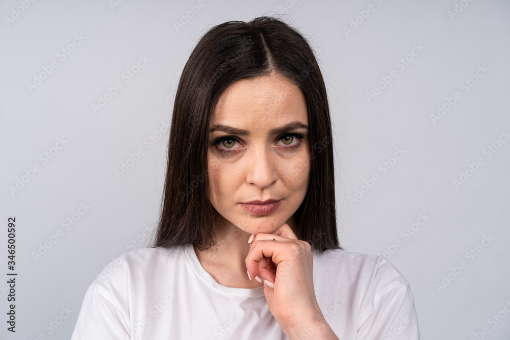 Portrait of a young girl with the dissolved hair, she looks with distrust, emotions Portrait of a young girl with the dissolved hair, she looks with distrust, emotions