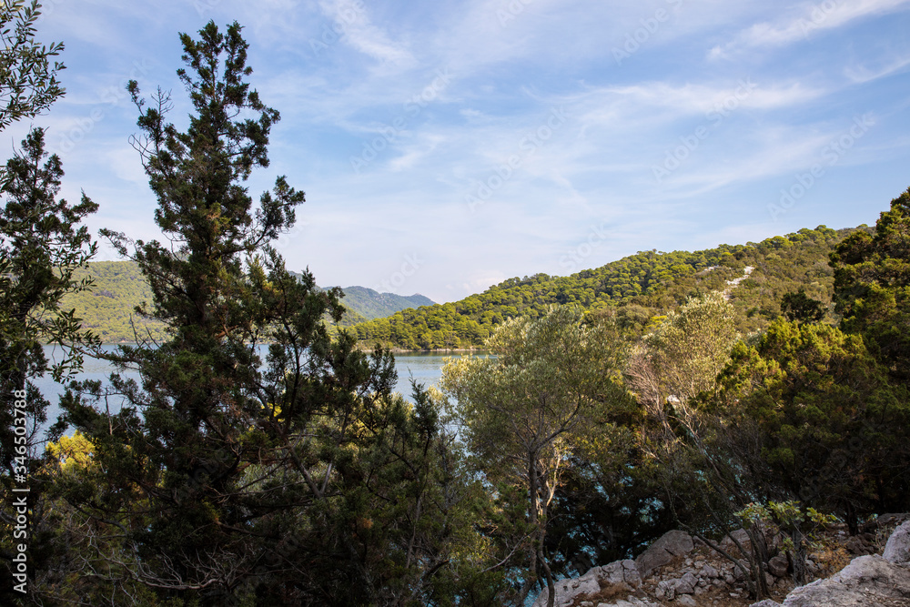 National Park on the island Mljet, Croatia. Mediterranean coast with greenery, pinetrees in the beautiful nature creating a serene calm scene, Small lake turquoise bright colored saltwater lakes National Park on the island Mljet, Croatia. Mediterranean coast with greenery, pinetrees in the beautiful nature creating a serene calm scene, Small lake turquoise bright colored saltwater lakes