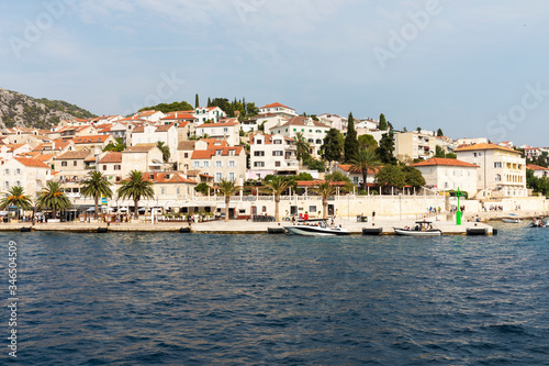 Hvar town on Hvar island, view from the sea on a sunny day in the summer blue sky. Clear adriactic water, the south mediterranean coast of Croatia Europe. Beautiful landscape with greenery