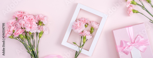 Mother's Day, Valentine's Day background design concept, beautiful pink carnation flower bouquet on pastel pink table, top view, flat lay, copy space.