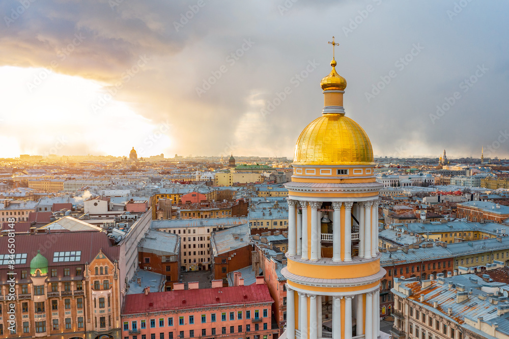 Vladimir Cathedral with golden shine domes and a bell tower in the city of St. Petersburg, aerial height view at evening sunset.
