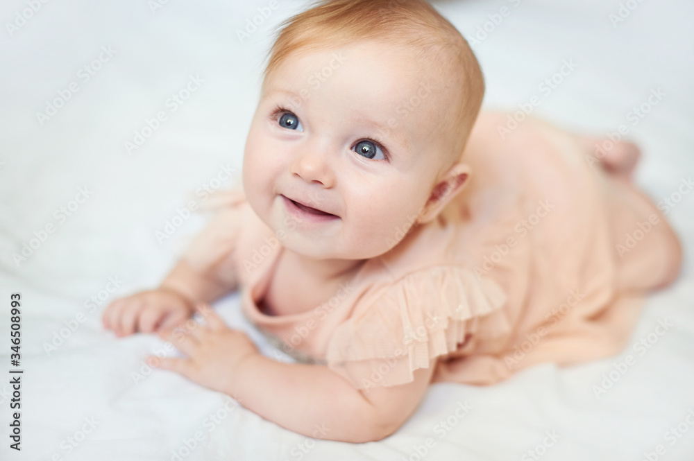 Portrait of a sweet infant smile wearing a pink dress in studio Portrait of a sweet infant smile wearing a pink dress in studio