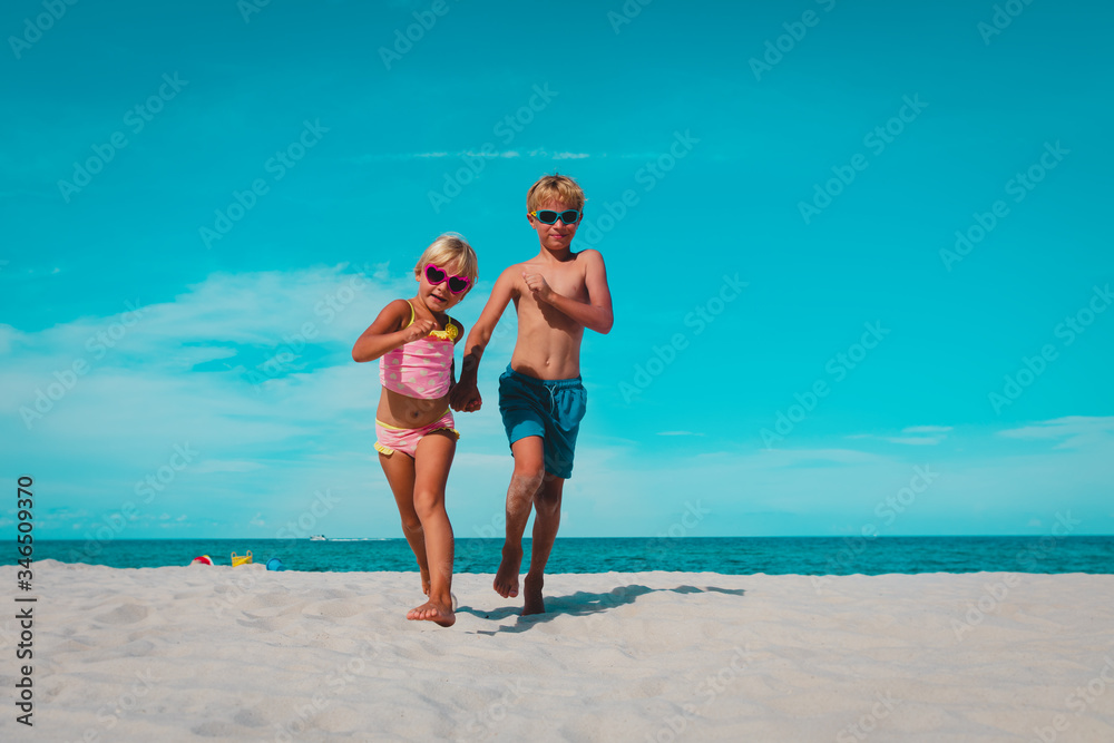 happy boy and girl running on beach happy boy and girl running on beach