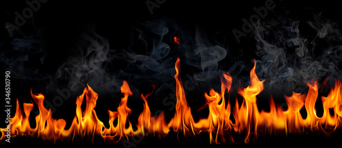 Fire flames with smoke on black background, Burning red hot sparks rise, Fiery orange glowing flying particles