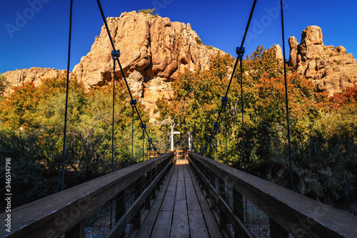 Wooden bridge in Boyce Thompson Arboretum Arizona, USA, magma rock at the backdrop