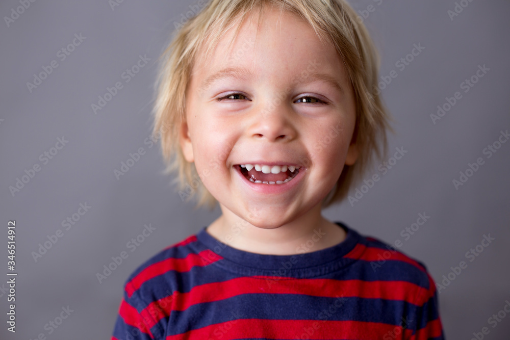 Child, boy, showing different emotions, isoalted shot on gray Child, boy, showing different emotions, isoalted shot on gray