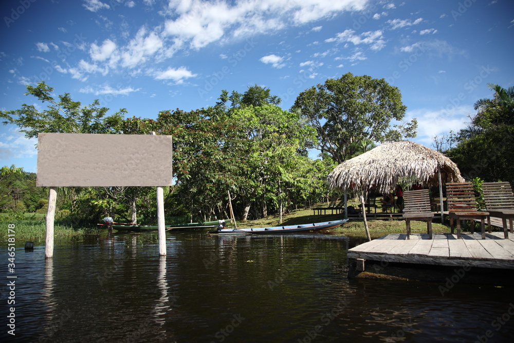 Amazon Jungle river lodge with boats and deck floating on water, Brazil Amazon Jungle river lodge with boats and deck floating on water, Brazil