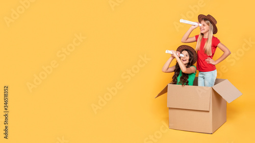 Copy-space girls playing aviator in carton box