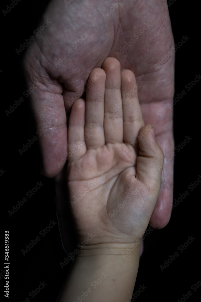 Fototapeta premium Father and son holding hands. Helping hands