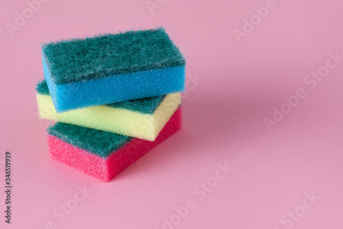 Kitchen cleaning sponge on pink background. Stack of sponges with copy space. 