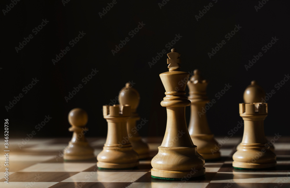 Wood King chess standing in the front of another, Chess board game for business ideas, competition, stratagy plan with success of team and reader. Wood King chess standing in the front of another, Chess board game for business ideas, competition, stratagy plan with success of team and reader.