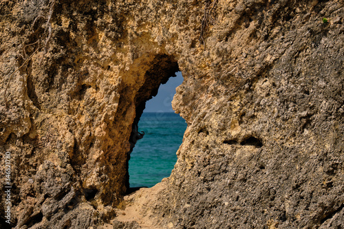 White beach of Boracay island. View through a tunnel in the rock to the sea. A few days before the outbreak of the coronavirus.