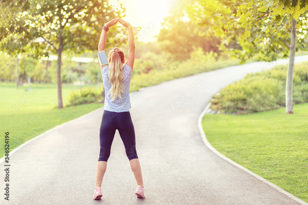 Woman stretching before morning jogging in park