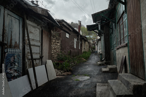 Slums of Russia. Old poor street in the rain. The resort city of Russia Kislovodsk. Rain in a poor quarter.