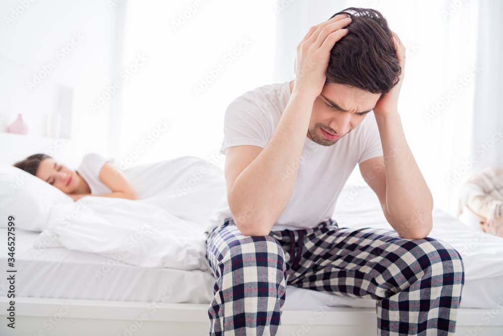 Photo of frustrated man sit bed suffer migraine head ache cant sleep his wife snore apnea loud wear white pyjama t-shirt in house indoors Photo of frustrated man sit bed suffer migraine head ache cant sleep his wife snore apnea loud wear white pyjama t-shirt in house indoors