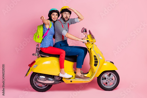 Look incredible view. Full size profile side photo crazy biker driver scooter woman point indicate street landscape wear casual rucksack bag clothes isolated pastel color background