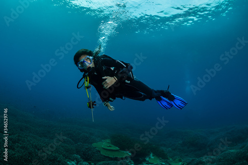 woman divng over a field of staghorn coral