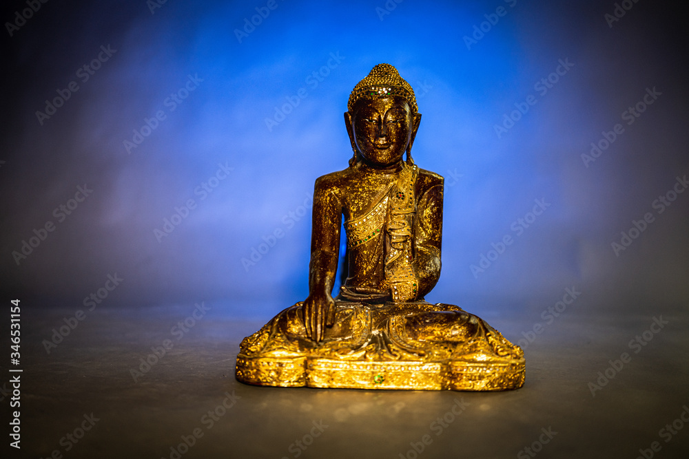 Golden Buddha in blue background Golden Buddha in blue background
