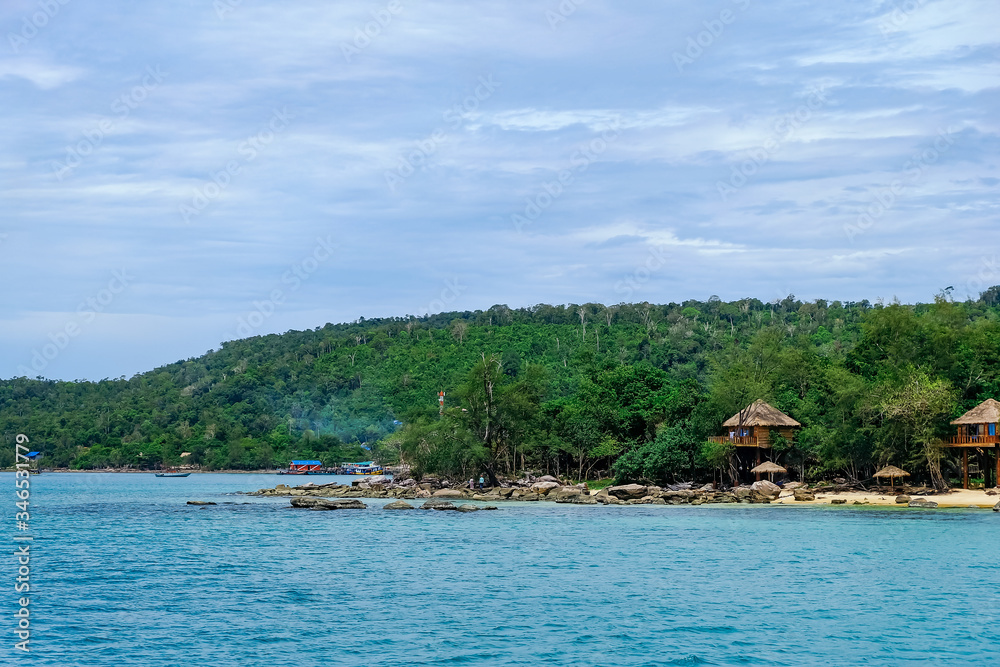 Obraz premium The beautiful tropical beach of Koh Rong, the paradise island with a nice bungalow, forest, coast, and white sand. Koh Rong island is a popular tourist destination in Sihanoukville, Cambodia