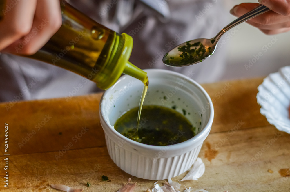 Adding olive oil to condiment sauce - preparing food Adding olive oil to condiment sauce - preparing food