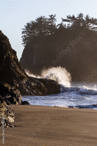 Waves crashing on a rock in Secret Beach, Oregon photo