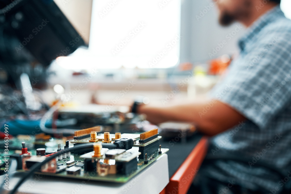 IT specialist repairing hardware and software, Closeup of workplace with printed circuit board
