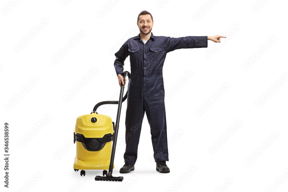Male worker from a cleaning cervice with a hoovering machine pointing to the side Male worker from a cleaning cervice with a hoovering machine pointing to the side