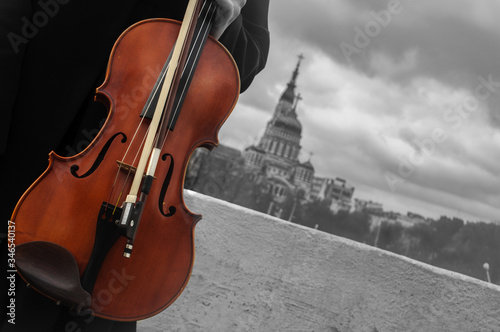 Music violin in hand in the city black and white