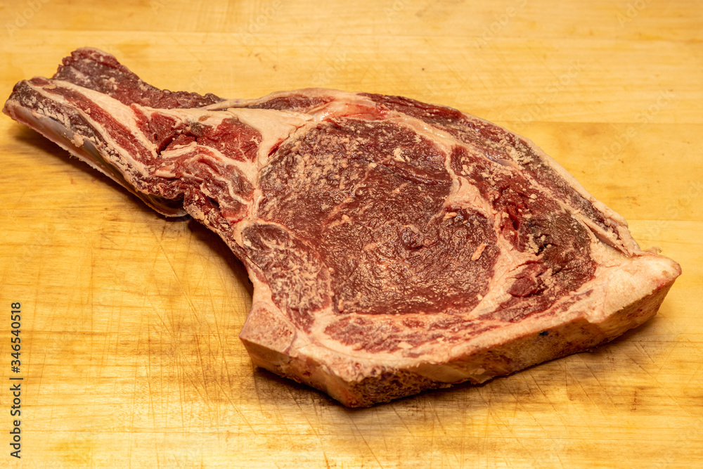 Obraz premium Tomahawk steak on a wooden board