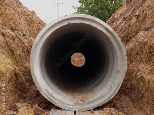 Vertical concrete drain in the hole Drainage systems under construction at the construction site On the ground background. Selective focus