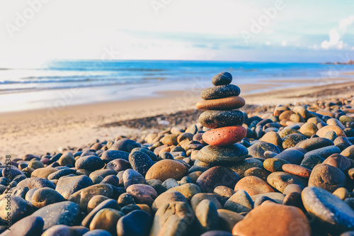Close up of rocks stacked one on top of another with soft selective focus. Stones are naturally balanced on the background of the sea. High-quality free stock images of rocks and landscapes