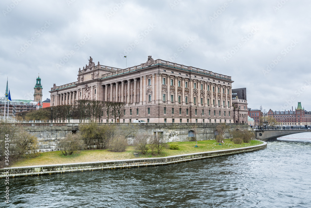 Riksdag (Parliament) Building at the bank of canal gainst cloudy sky in Stockholm, Sweden.