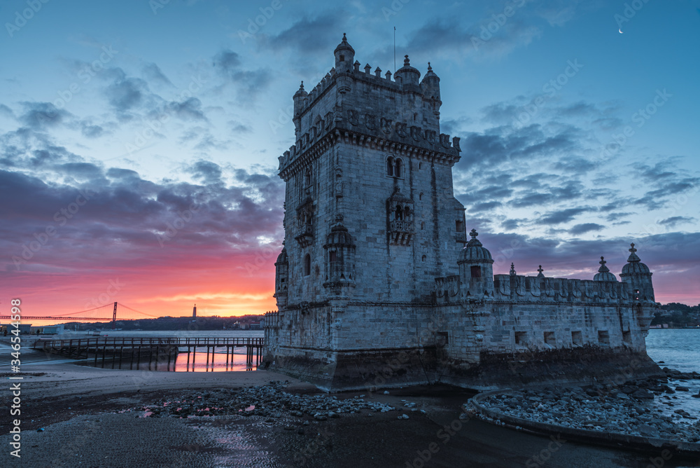 fire dawn on the belem tower in lisbon
