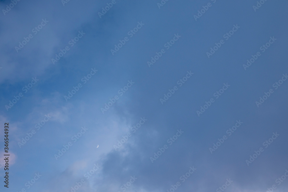the dark evening sky with moon and thick heavy clouds. Background with copy space for text the dark evening sky with moon and thick heavy clouds. Background with copy space for text